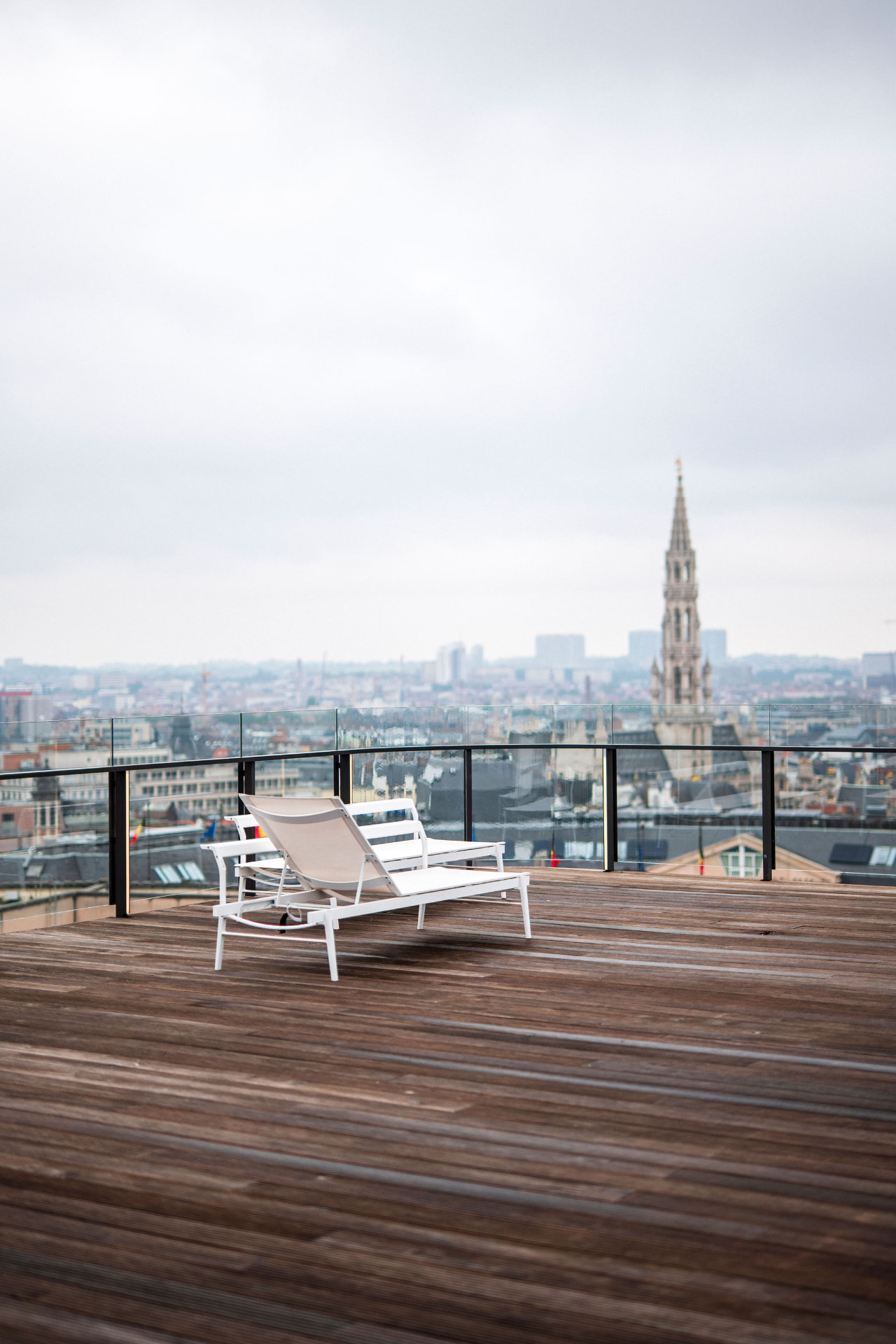Rooftop terrace with lounge chairs facing the city skyline
